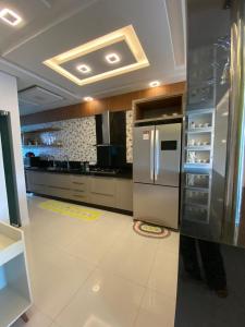 a kitchen with a stainless steel refrigerator and cabinets at Casa por temporada in Barreirinhas