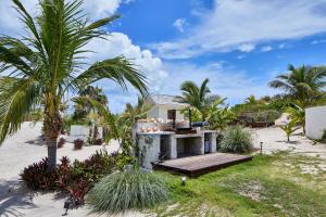 a house on the beach with palm trees at Bohemia Two Bedroom home in James Cistern +4 photos