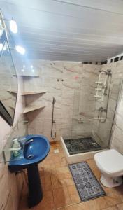 a bathroom with a shower and a blue sink at Renacer in Piriápolis +44 photos
