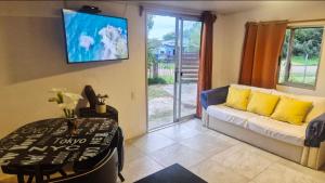 a living room with a couch and a table at Renacer in Piriápolis