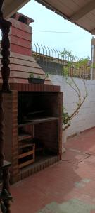 a brick fireplace on a patio with stairs at Casa a 2 cuadras del mar en Necochea in Necochea