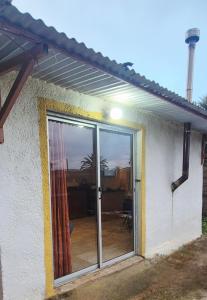 a sliding glass door of a house with a patio at Renacer in Piriápolis