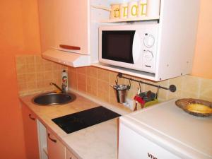 a small kitchen with a sink and a microwave at Charming Apartments Kestenovi Dvori- 1 Bedroom A3 in Opric