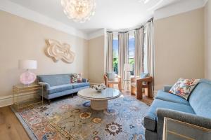 a living room with a blue couch and a table at Hennessey Estate in Napa