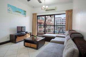 a living room with a couch and a television at KK Vacation Apartments-Marina Court - STAY AND GET CASH REBATE in Kota Kinabalu