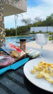 a table with a plate of food and a glass of wine at SouMaisTemporada RJ in Niterói