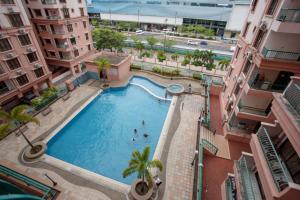 an overhead view of a swimming pool between two buildings at KK Vacation Apartments-Marina Court - STAY AND GET CASH REBATE in Kota Kinabalu