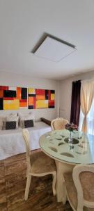 a living room with a table and two beds at Beautiful apartment in San Bernardo with terrace in Costa Azul
