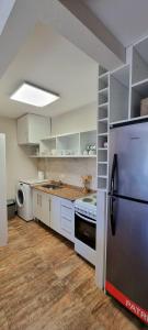 a kitchen with a refrigerator and a sink in it at Beautiful apartment in San Bernardo with terrace in Costa Azul