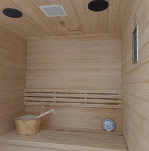 a sauna with a bucket and a clock in it at Villa Forko in Lopar +97 photos