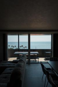 a living room with a couch and a view of the ocean at AWAJI OCEAN BASE east coast in Awaji