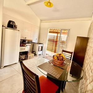 a kitchen with a table with a bowl of fruit on it at Lindo Chalé No Campo no Catarina Home Club em mairinque in Mairinque +24 photos