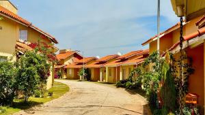 a row of houses with orange roofs on a street at Lindo Chalé No Campo no Catarina Home Club em mairinque in Mairinque