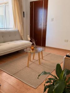a living room with a couch and a table at Departamento Moderno y céntrico in Salta +21 photos