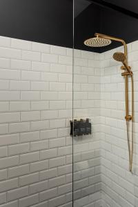 a shower with a glass door in a bathroom at The Victoria Hotel Rutherglen in Rutherglen