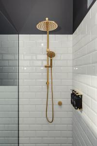 a bathroom with a shower with a shower head at The Victoria Hotel Rutherglen in Rutherglen +39 photos