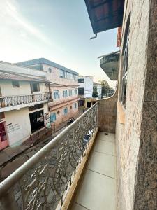 a balcony with a view of a city at Pousada King Stones - São Thomé das Letras - ÁREA CENTRAL in São Thomé das Letras
