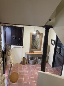 a room with a fireplace and a table with a mirror at El Rincón de la Tía Miguela in Puertomingalvo