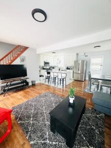 a living room with a couch and a table at Cheerful 4-bedroom home with free parking in Elmont
