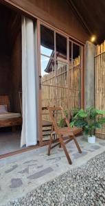 a wooden bench sitting outside of a building at Casa Elia San Juan La Union in San Juan