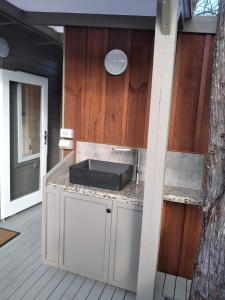 a outdoor kitchen with a sink on a deck at The Tawnys Gatehouse 
