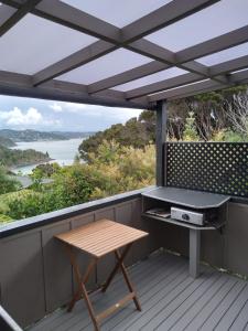 a picnic table on a deck with a view of the ocean at The Tawnys Gatehouse  +16 photos