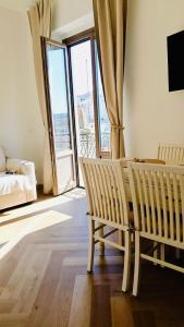 a living room with a couch and a bed and a window at Cuore Antico - Il Monastero Sul Mare in Vieste