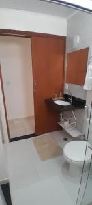 a bathroom with a toilet and a sink at Apartamento Baixu 1 in Prado +21 photos