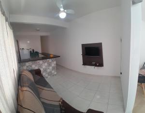 a living room with a flat screen tv on the wall at Apartamento Baixu 1 in Prado