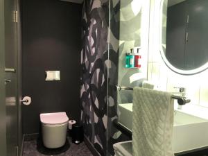 a bathroom with a toilet and a tub and a sink at Rockefeller Foreshore Studio Fast WiFi, Gym & Pool in Cape Town +16 photos