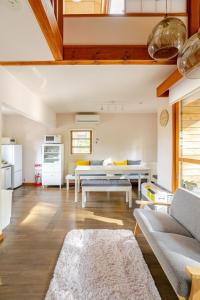 a living room with a couch and a table at Origami Chalet - Riverside in Hakuba