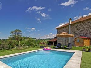 a swimming pool in front of a house at Gîtes confortables avec piscine, accueil animaux, cheminée, jardin - FR-1-496-140 in Belmont-de-la-Loire