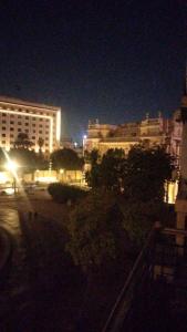 a city street at night with buildings and trees at Host-Gram Hotel & Suites Downtown in Cairo