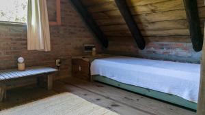 a bedroom with a bed and a bench in a room at Posada Hale Koa in La Paloma