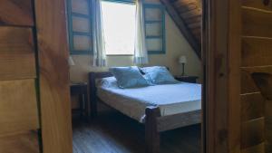 a small bed in a room with a window at Posada Hale Nalu in La Paloma +9 photos