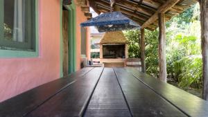 a wooden table in a house with an outdoor oven at Posada Hale Nalu in La Paloma