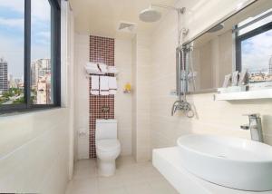 a bathroom with a toilet and a sink and a window at Thank You Hotel Sanya Bay Coconut Dream Corridor Branch in Sanya +16 photos