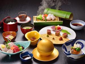 a table topped with plates and bowls of food at Ryuguden in Hakone