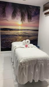 a bedroom with a bed with a painting of the ocean at Canal-Front Luxury 3BR City & Golf Views Private in Cocolí +71 photos