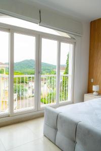 a bedroom with large windows and a bed and a balcony at Canal-Front Luxury 3BR City & Golf Views Private in Cocolí