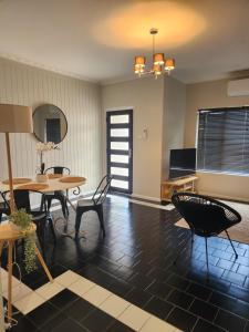 a living room with a table and chairs at Kindred Studio Apartments in Leeton