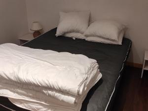 a bed with white sheets and pillows on it at Appartement Montagne 4 Pers, Balcon et Piscine - FR-1-814-162 in Super Besse