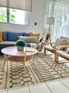 a living room with a couch and a table at The Choliseo Bayside Stay in San Juan