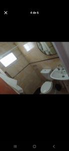 a bathroom with a toilet and a sink at La fortaleza A una cuadra de la terminal in Concordia