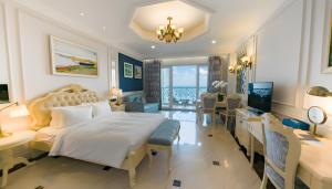 a hotel room with a bed and a desk and a bedroom at Lan Rung Beach Resort in Long Hai