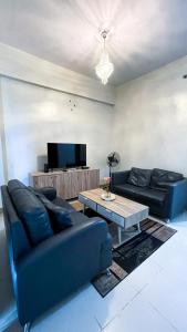 a living room with a couch and a coffee table at 13 Twin Balcony Escape in Iloilo City