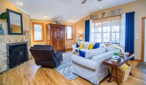 a living room with a couch and a fireplace at Waterfront Getaway|Fire Pit|Kayaks|Foosball in Seguin