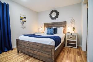 a bedroom with a bed and a mirror on the wall at Waterfront Getaway|Fire Pit|Kayaks|Foosball in Seguin