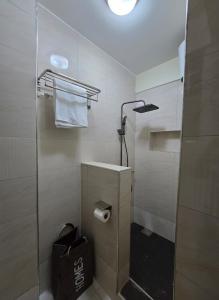 a bathroom with a shower with a glass door at Vibrant City Haven in the Heart of Kampala in Kampala