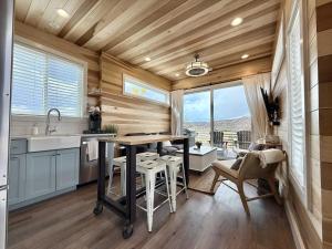 a kitchen with a table and chairs and a large window at Escalante Escapes Holly Hock- King Escape in Escalante